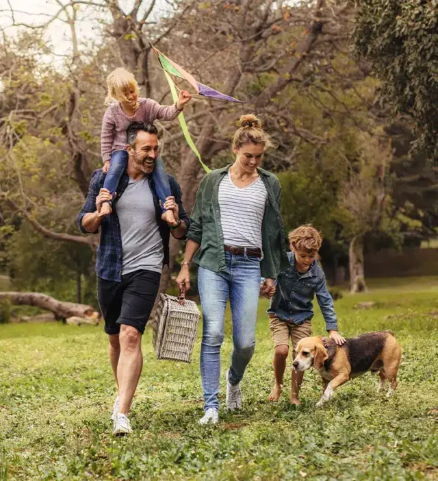 A family of four and a dog having fun outdoors