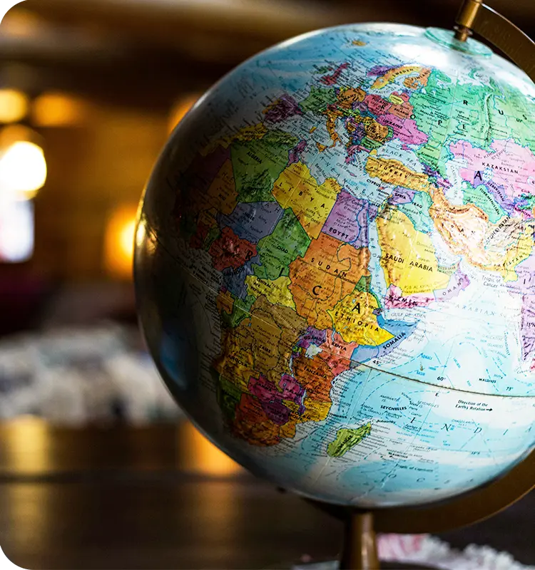 A globe with a dimmed background and a shadow falling on the left side of the globe.